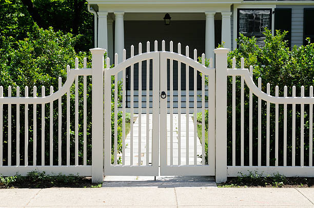 Front gate and white fence on elegant house entrance