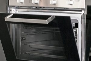 Big silver electric oven in the black kitchen