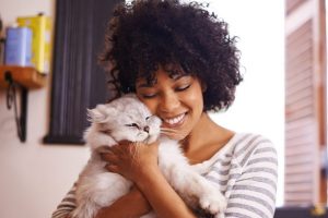 cat-being-hugged-by-woman