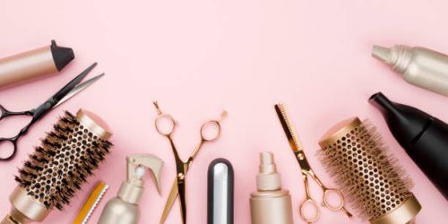 Various hair dresser tools on pink background with copy space Various hair dresser tools on pink background with copy space