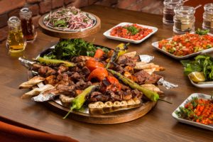 Traditional Turkish Kebabson wooden table. Kebabs are various cooked meat dishes, with their origins in Middle Eastern cuisine.