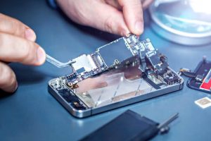 serviceman-is-repairing-a-damaged-mobile-phone-933640672-1258x838-1